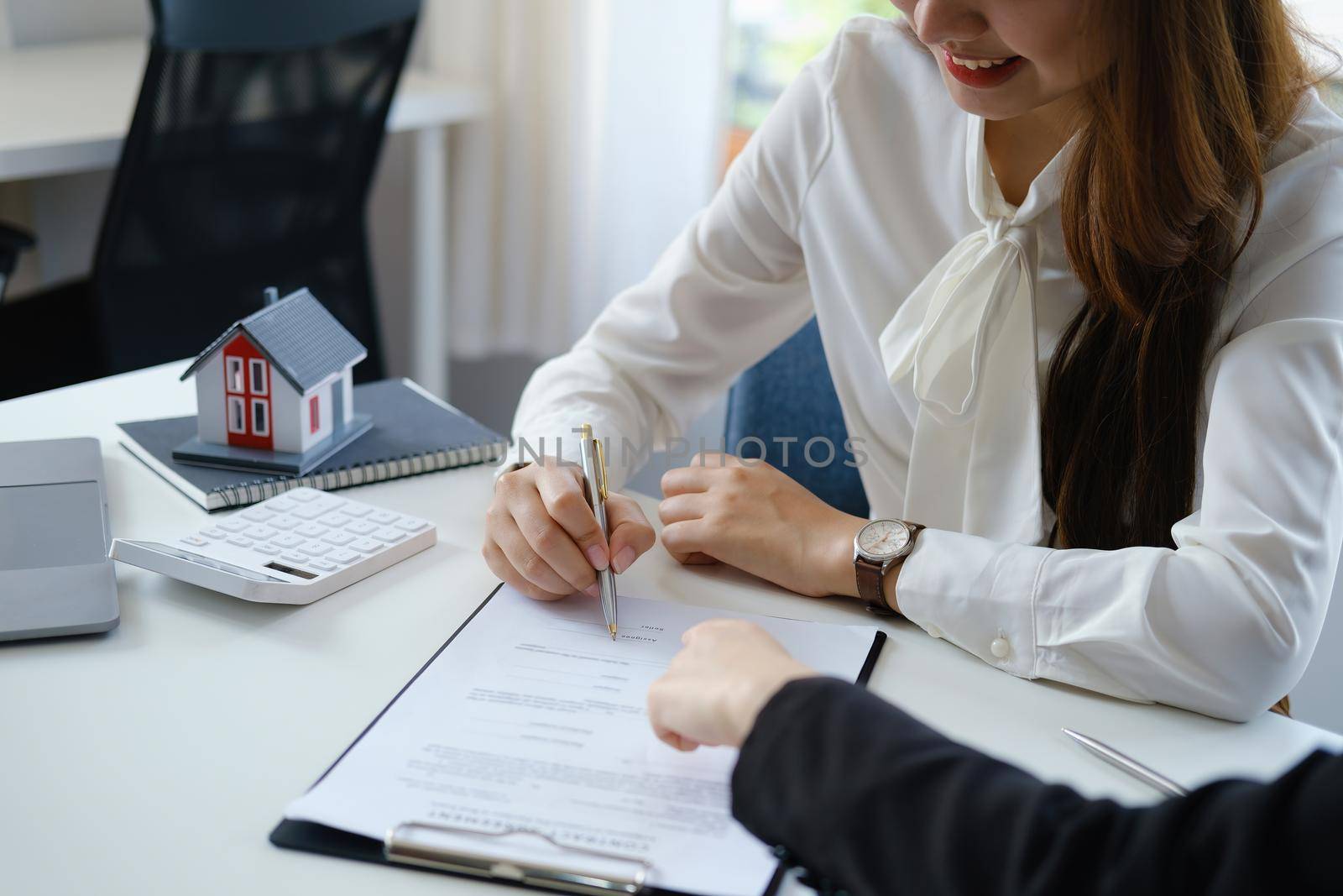 Guarantee, mortgage, agreement, contract, sign, the customer is signing the contract document as evidence to the real estate agent or bank officer according to the agreement according to the document by Manastrong