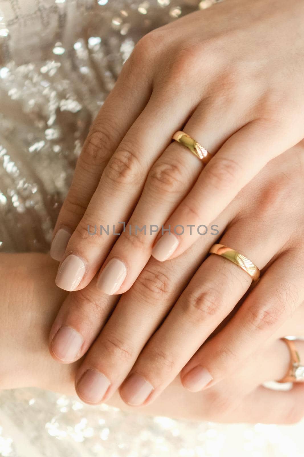 Close up of wedding rings on hands of newlyweds. Hands of the bride and groom