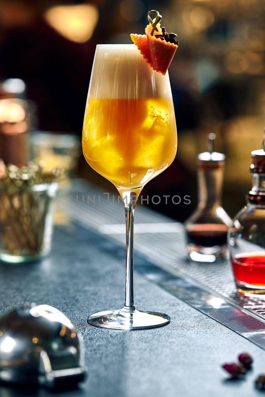 Rosemary cocktail - golden rum, rosemary, fruits juice and syrup on a gray bar counter. Still life