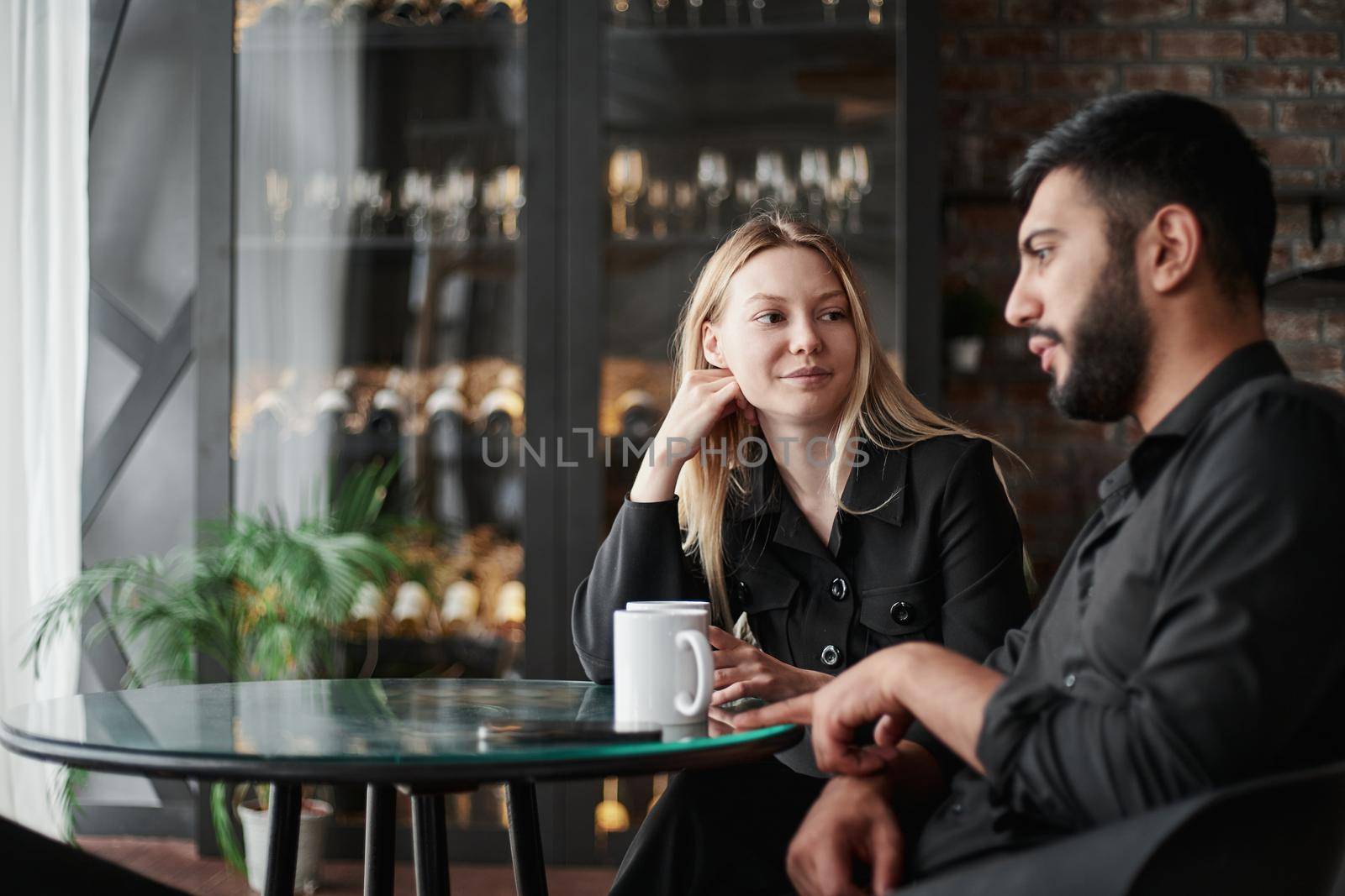 businessman and businesswoman talking sitting at a table in a cafe. close-up.
