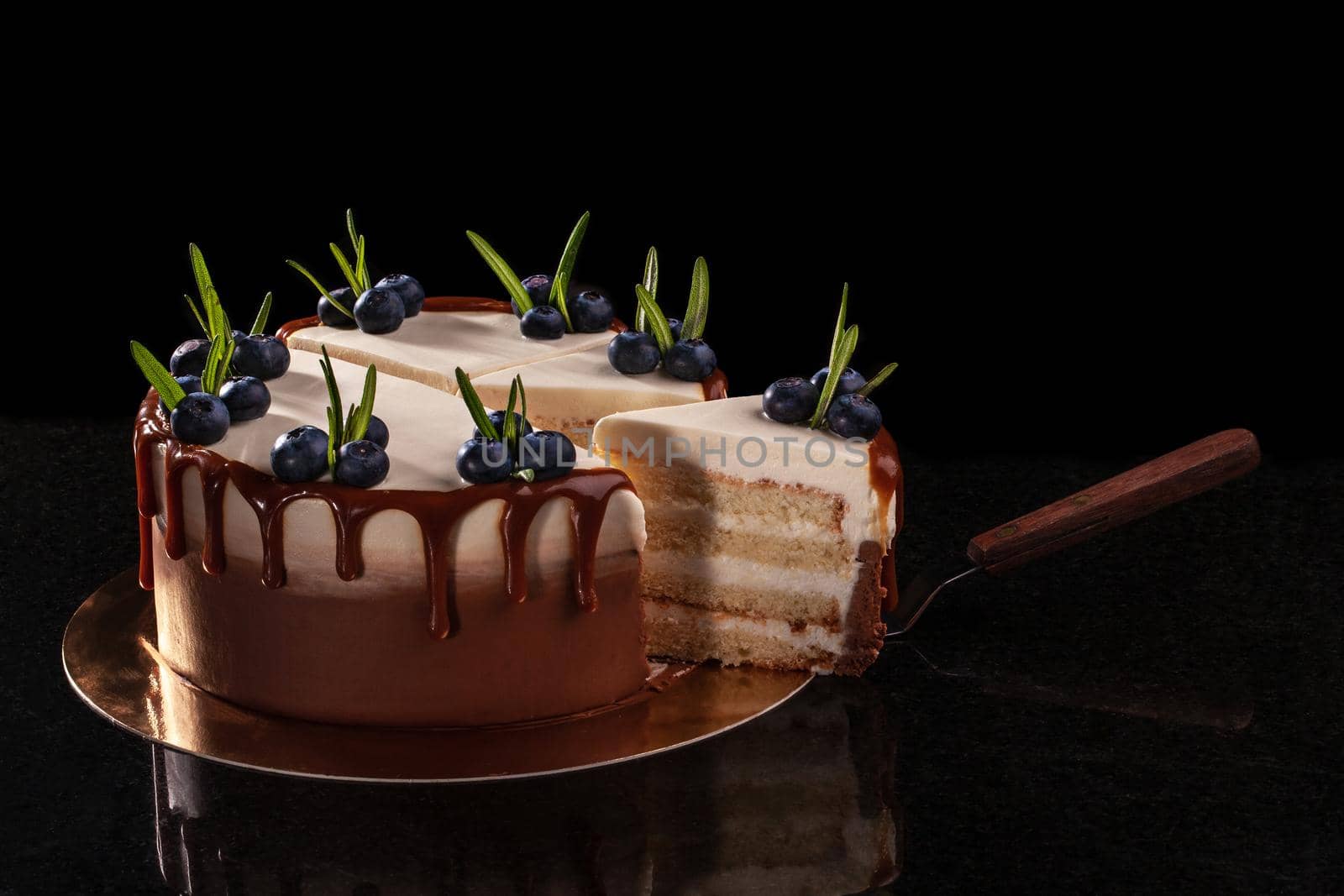 Cake with blueberries on a black background, decorated with small green leaves and fresh berries. by nazarovsergey