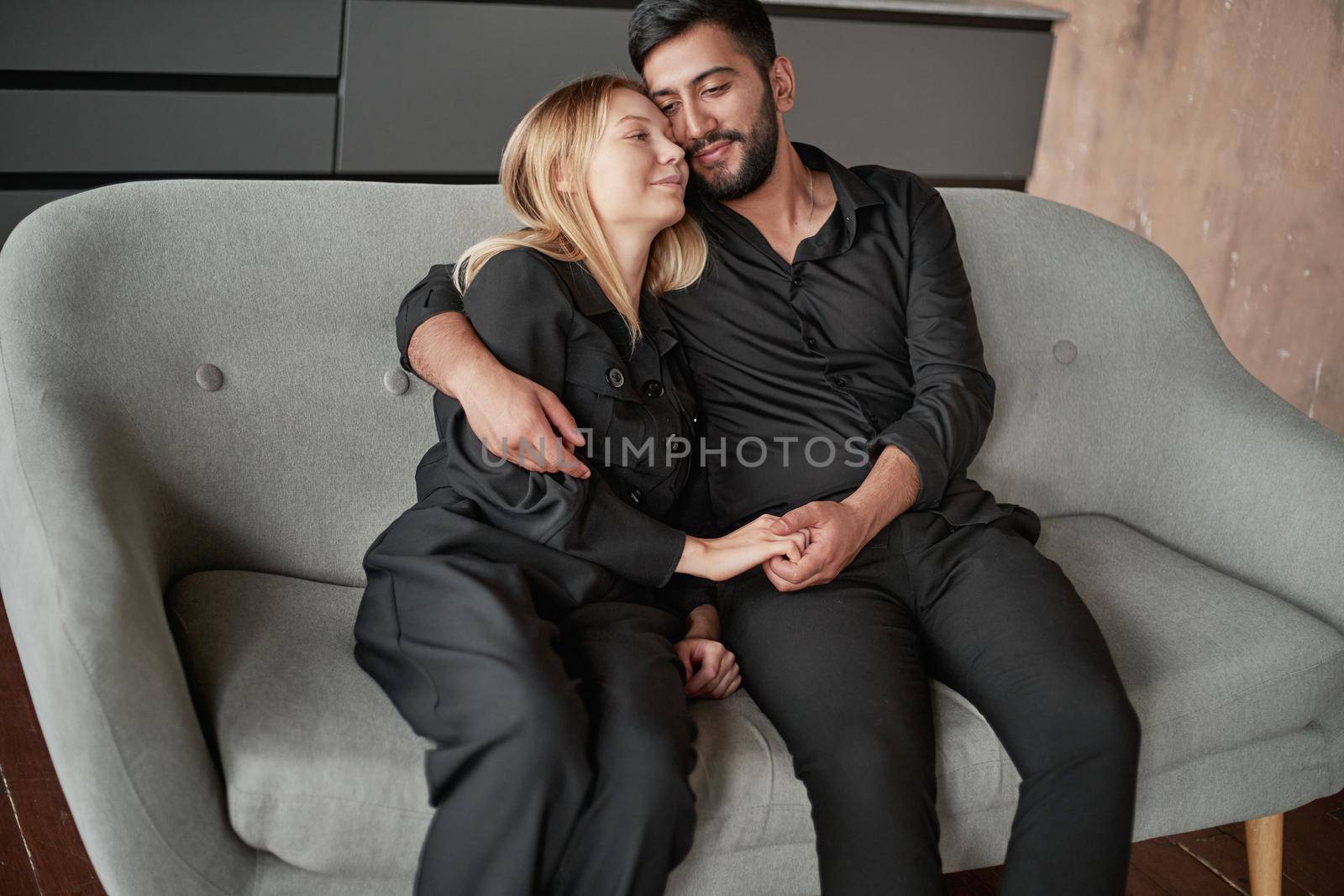 happy married couple sitting on the couch. close-up.