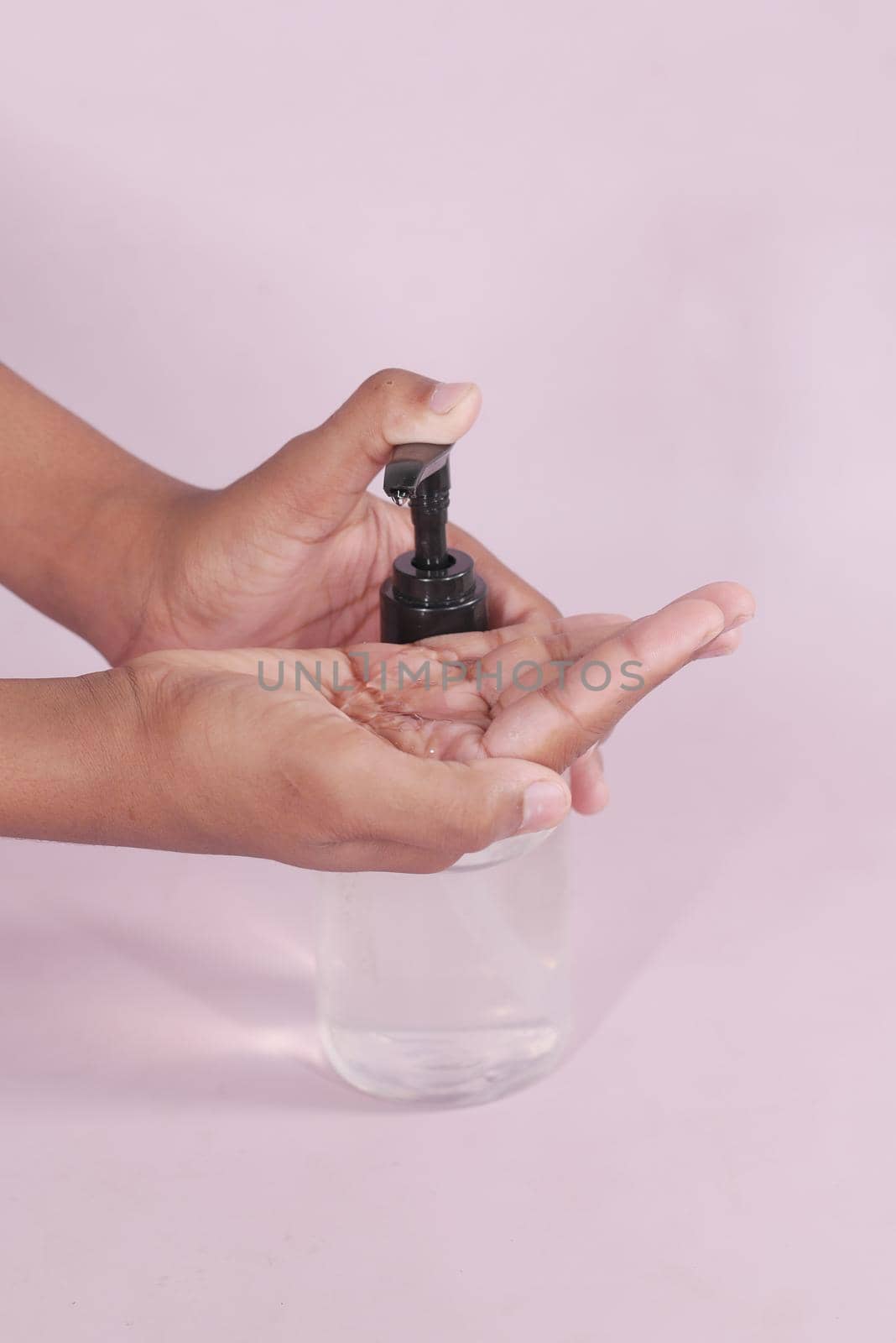 close up of young man hand using sanitizer gel for preventing virus.