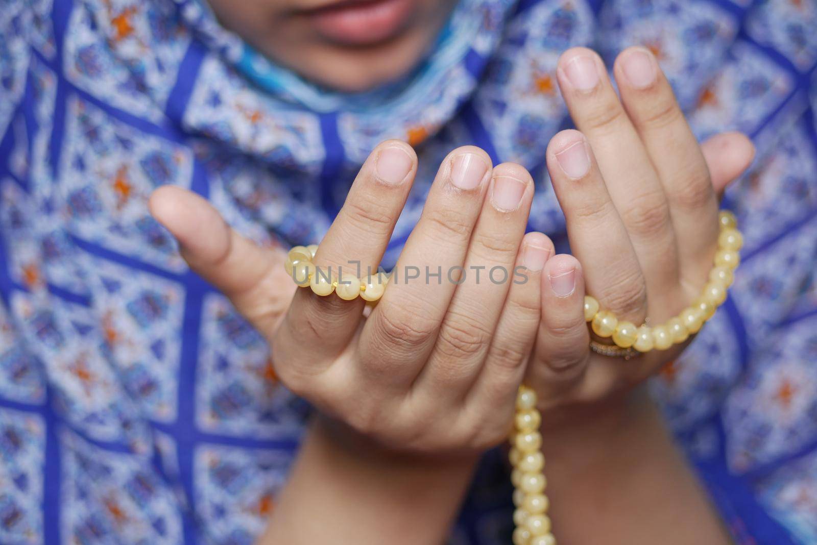 Close up of muslim women hand praying at ramadan .