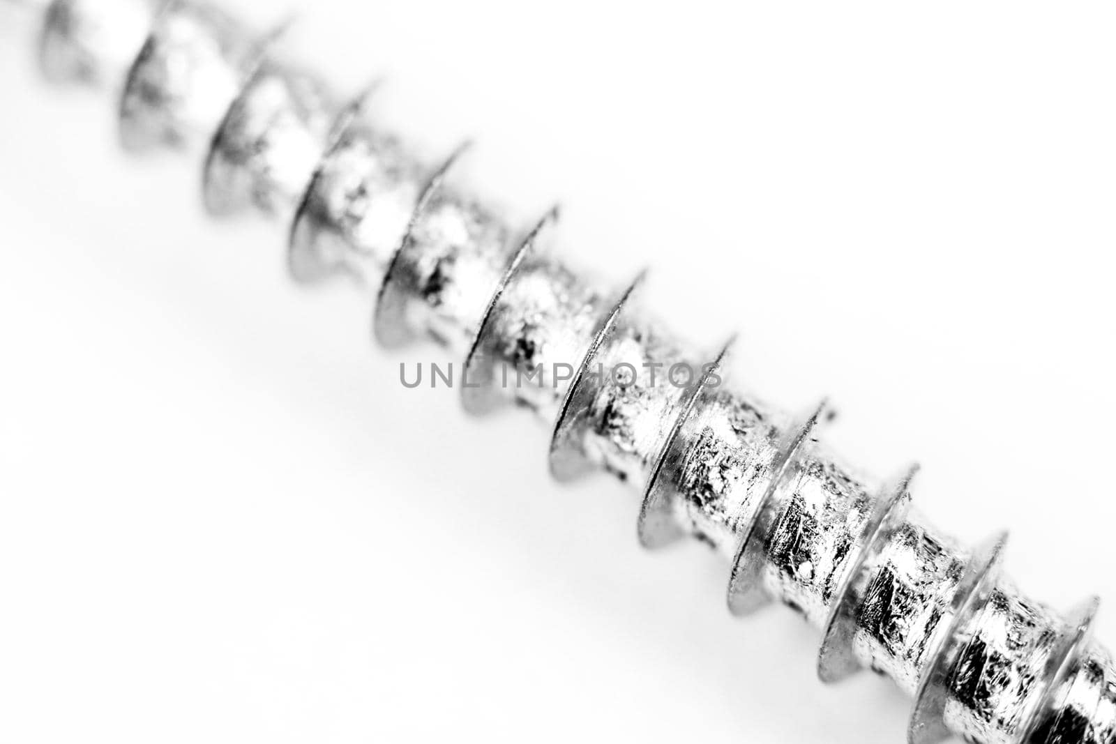 Macro photography of external screw thread on white background