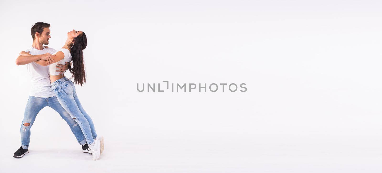 Banner with couple dancing social latin dance bachata, merengue, salsa. Two elegance pose on white background with copy space by Satura86
