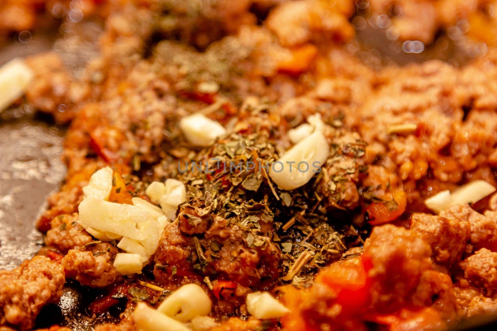 Bolognese ragout in a frying pan with wooden spoon, authentic recipe, close-up by Milanchikov