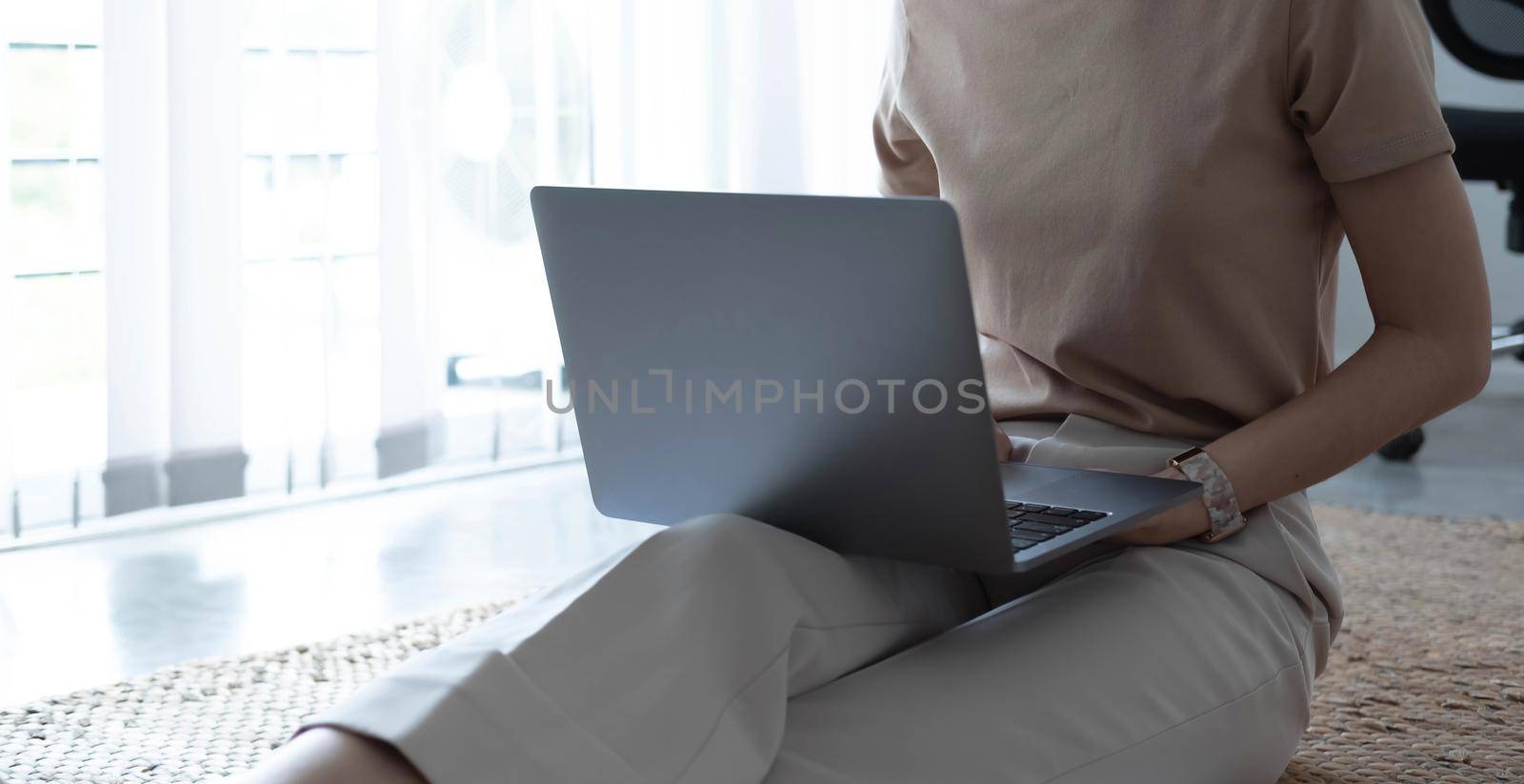 Close up image of woman hands typing on laptop computer keyboard and surfing the internet on office table, online, working, business and technology, internet network communication concept by wichayada