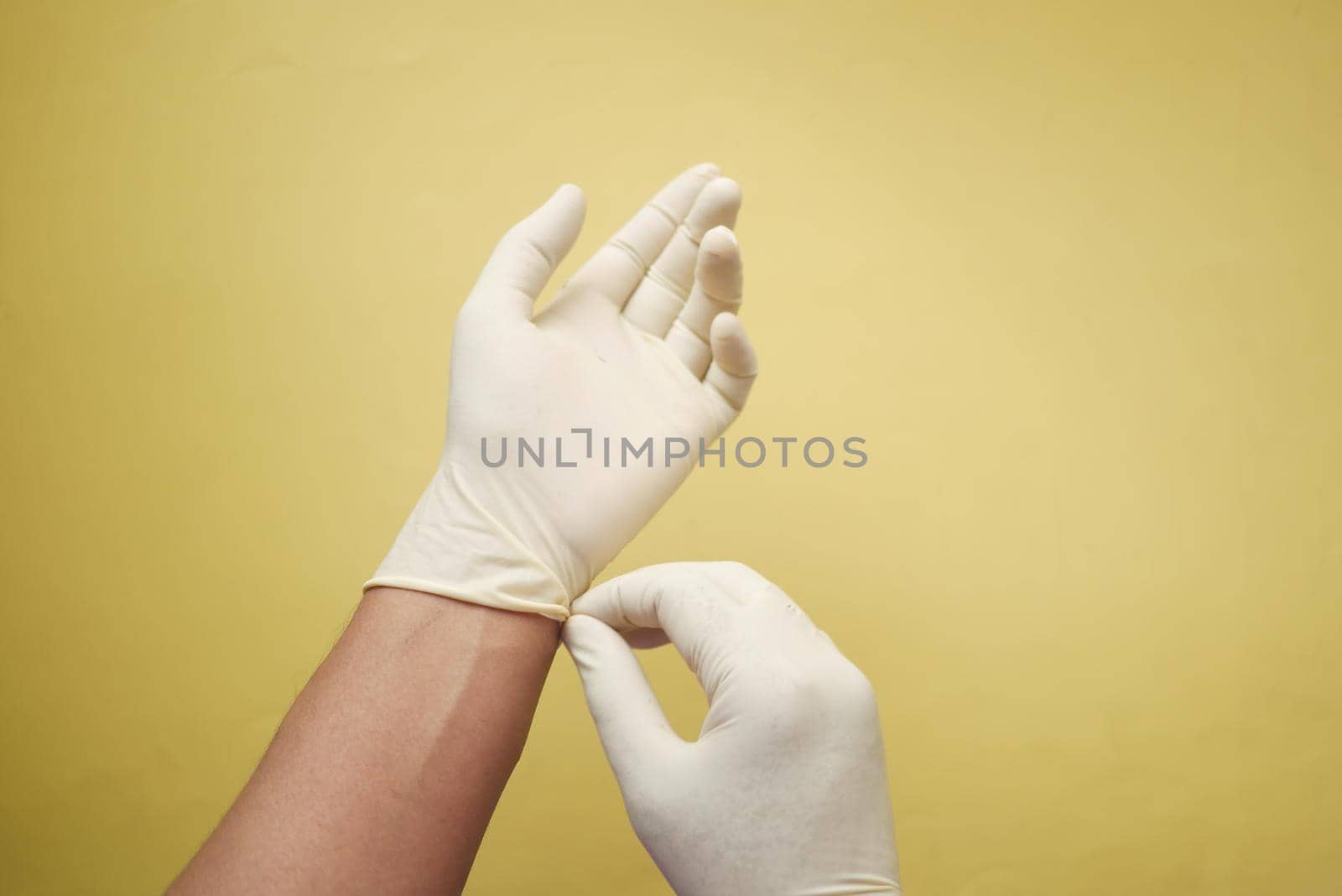 man doctor wears medical gloves.