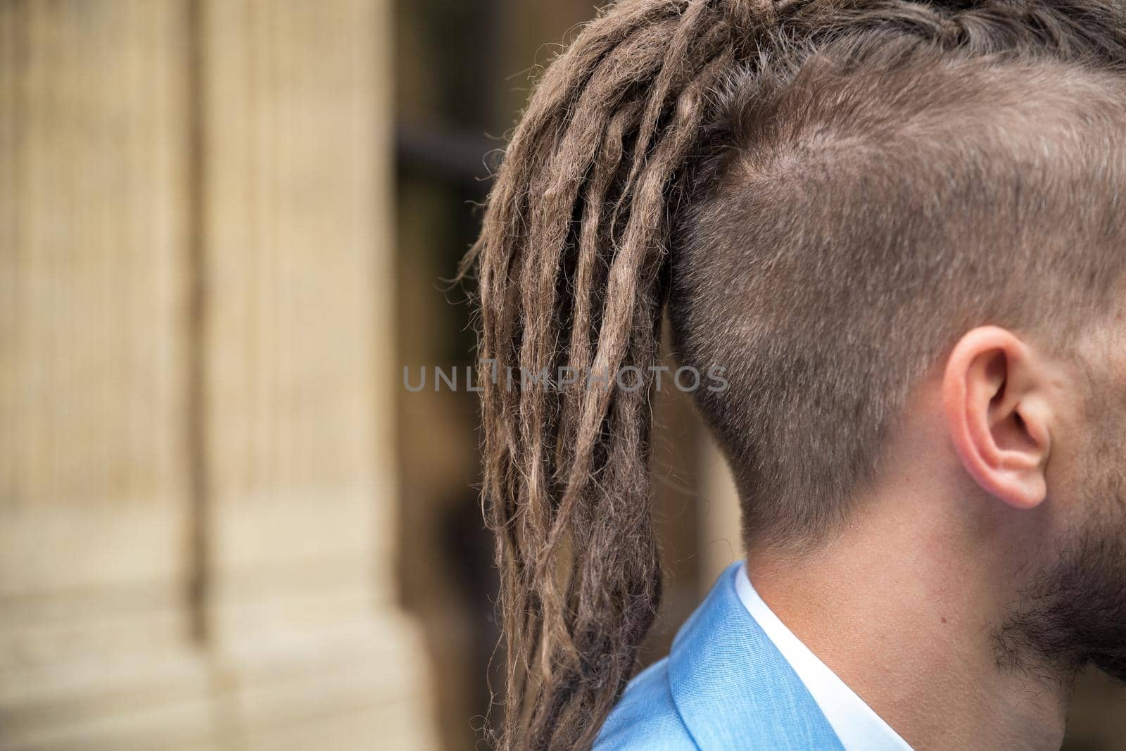 Close-up on hipster hairstyle with dreadlocks outdoors.