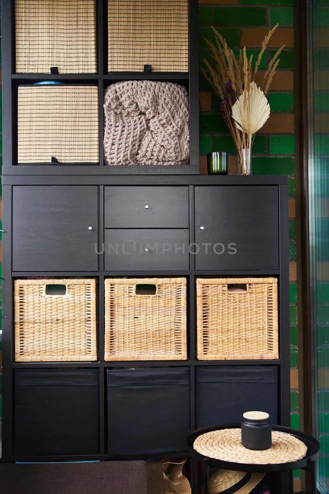 Wicker boxes for things on the shelves. Wardrobe for storage of things by driver-s