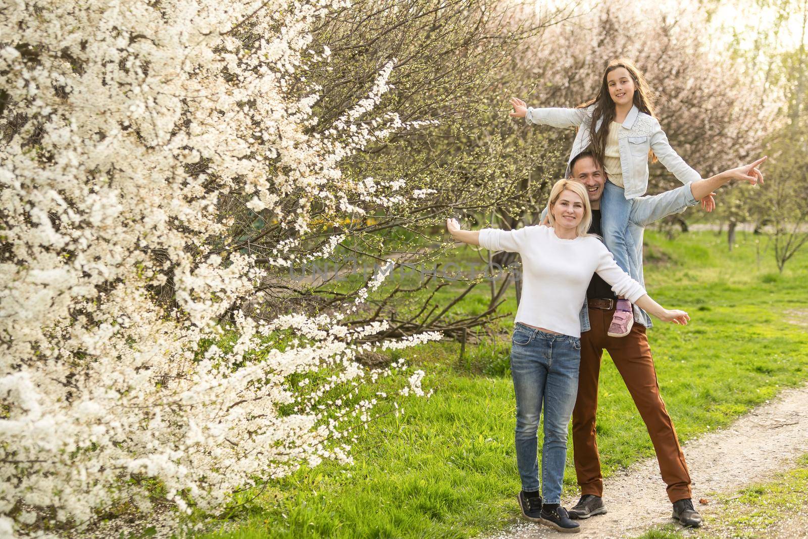 Family and child outdoors in spring nature, resting. by Andelov13