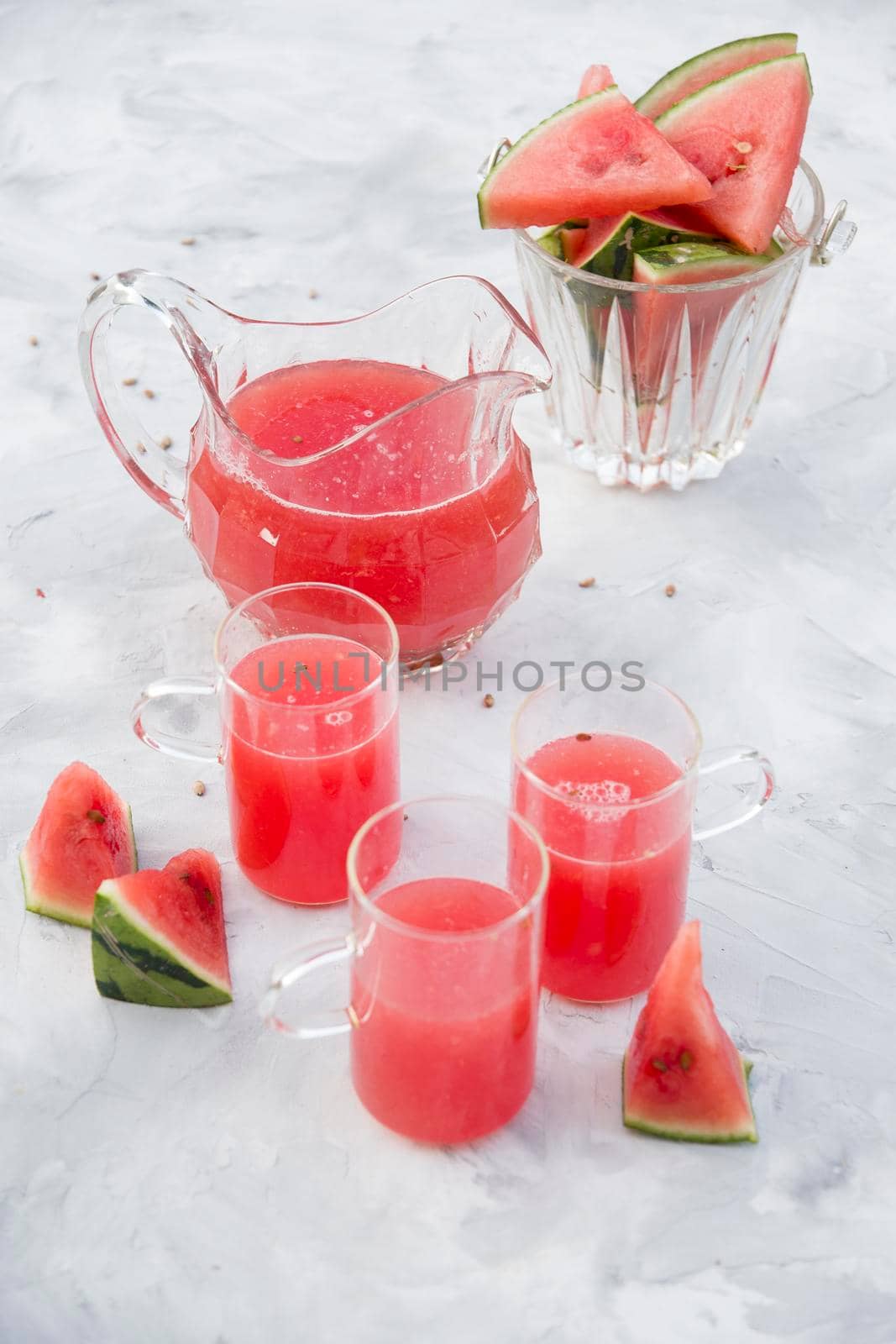fresh red watermelon drink on hot summer day on light gray cement background. High quality photo