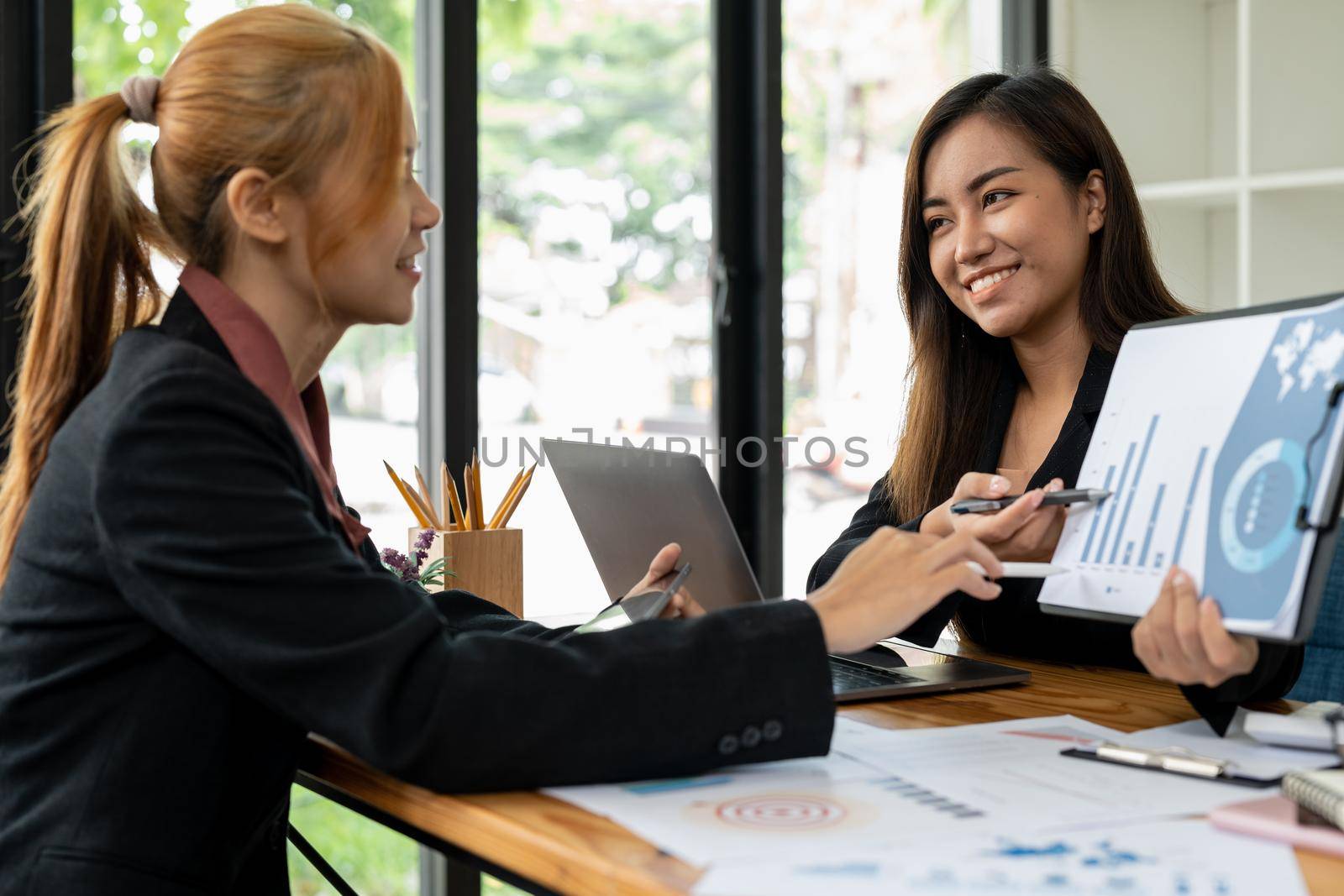 Asian business adviser meeting to analyze and discuss the situation on the financial report in the meeting room.Investment Consultant, Financial advisor and accounting concept.