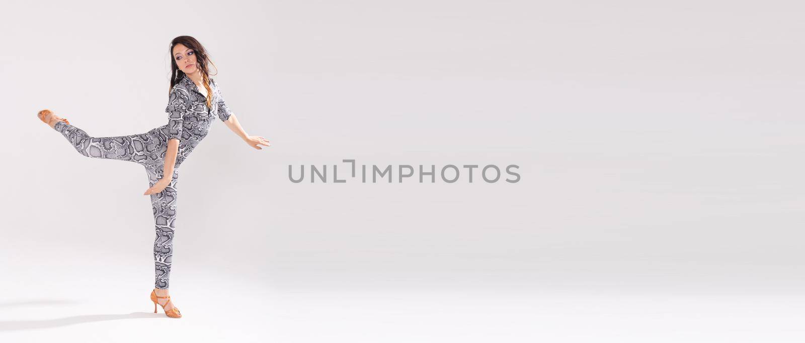 Latin dance, bachata lady, jazz modern and vogue dance concept - Beautiful young woman dancing on white background