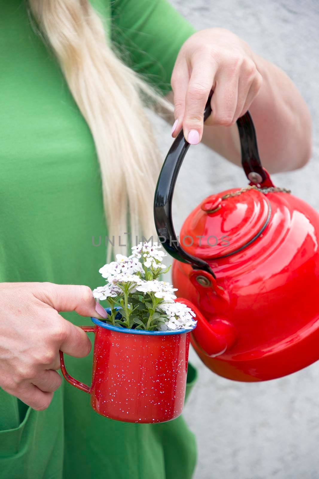 a blonde girl with long hair in a bright green dress holding a red mug by KaterinaDalemans