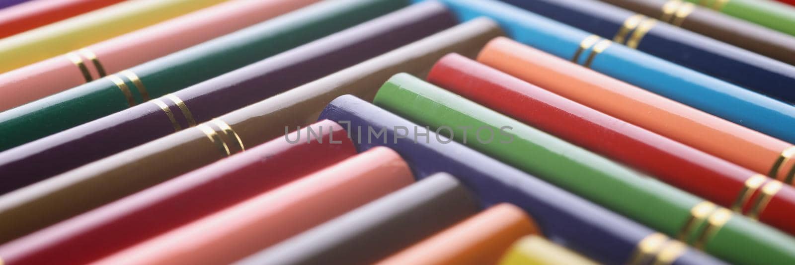 Close-up of stack of colored pencils placed in creative order with golden design on it. All colours for your bright imagination. Create masterpiece concept