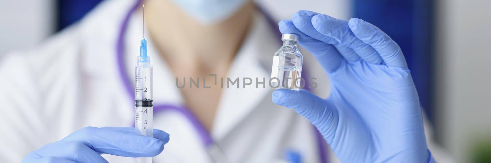 Close-up of medical worker holding syringe and bottle with vaccine for coronavirus cure. Corona virus treatment and injection. Stop pandemic, shot concept