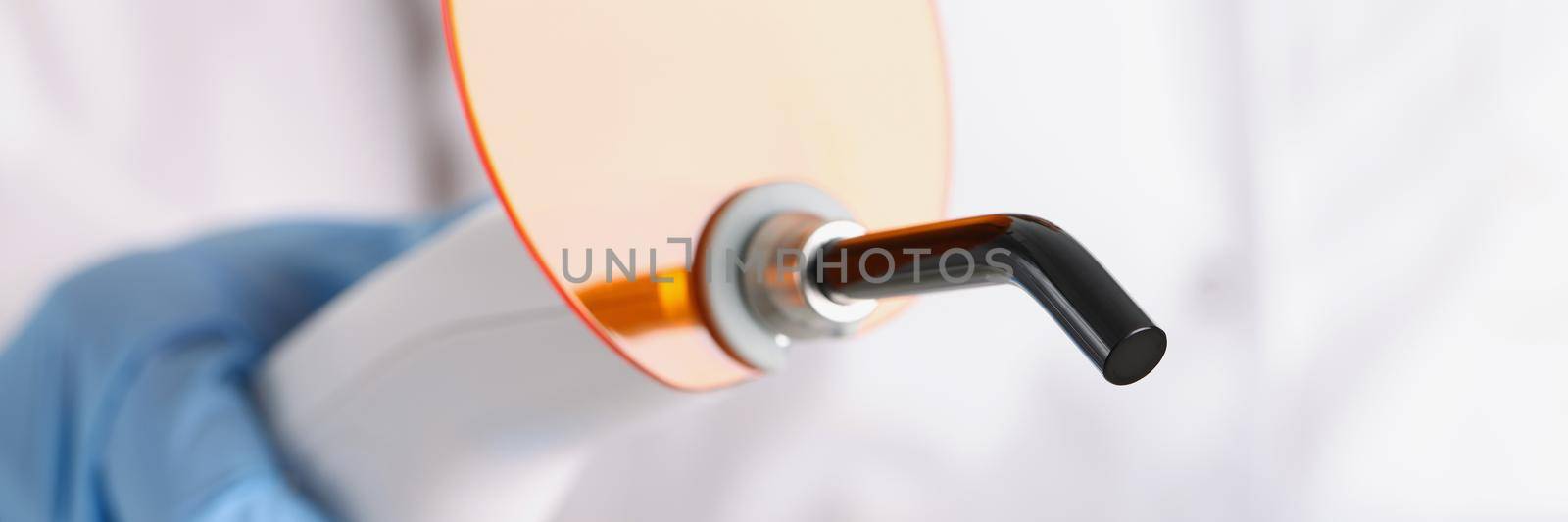 Close-up of dentist professional equipment for tooth whitening or cleanse procedure. Doctor going to use tool on patient in clinic. Stomatology concept