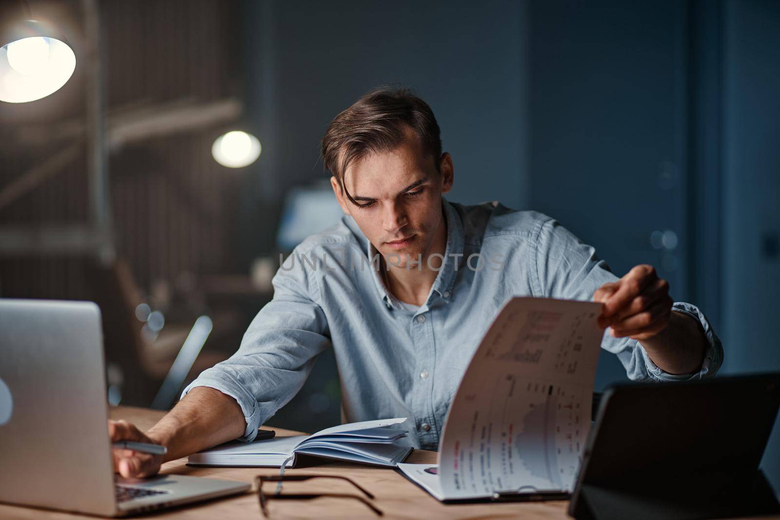 businessman using a laptop to work with documents . by SmartPhotoLab