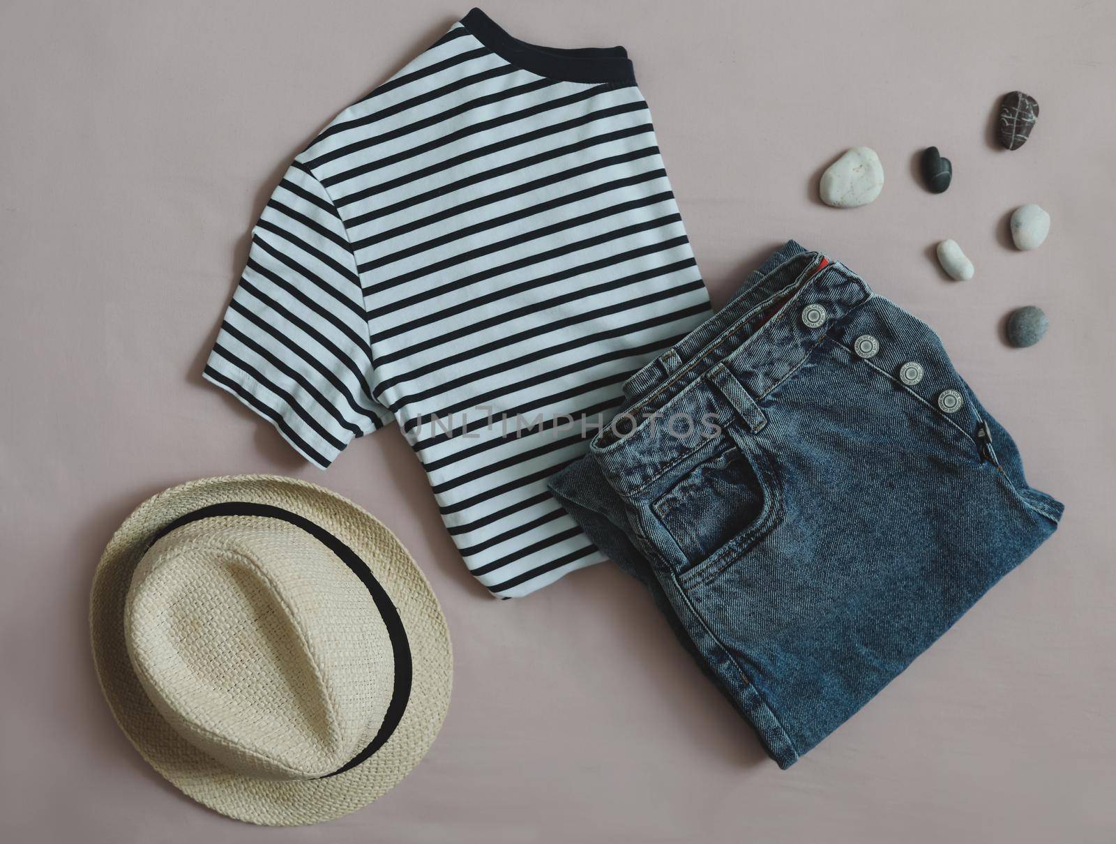 Summer fashion, vacation on sea. flat lay with top, denim shorts, straw hat top view.