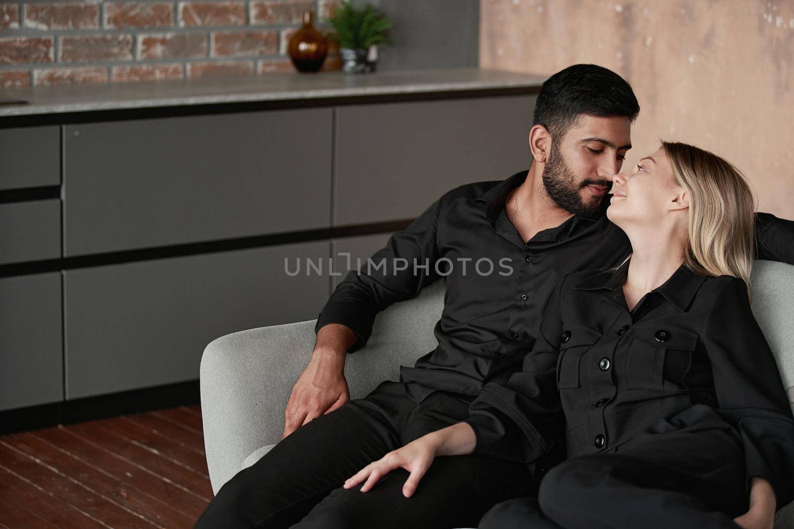 loving husband and wife dream sitting on the couch. by SmartPhotoLab