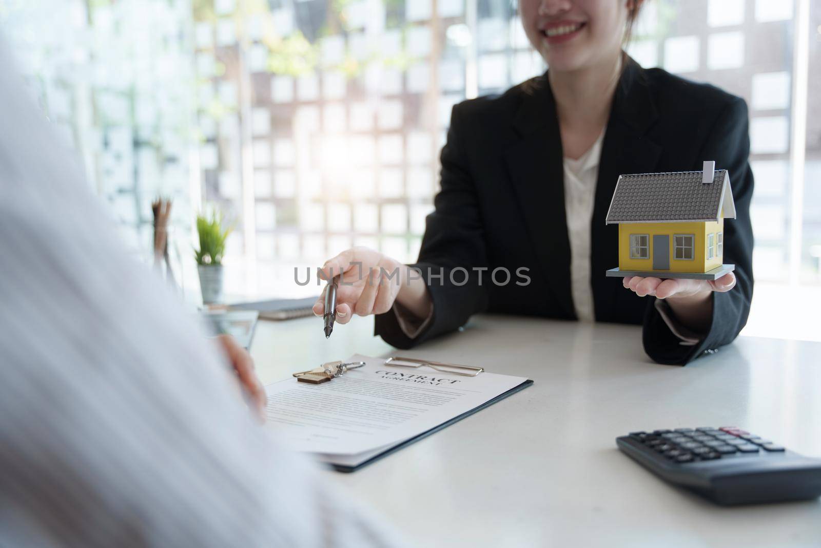 Guarantee, mortgage, agreement, contract, signed, real estate agent pointing to documents for customers to read the agreement before signing important documents.