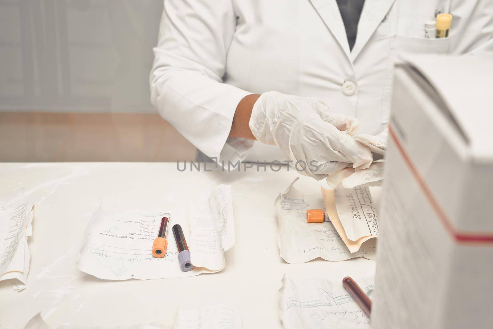 Unrecognizable Latina clinical laboratory worker sorting blood samples in a hospital