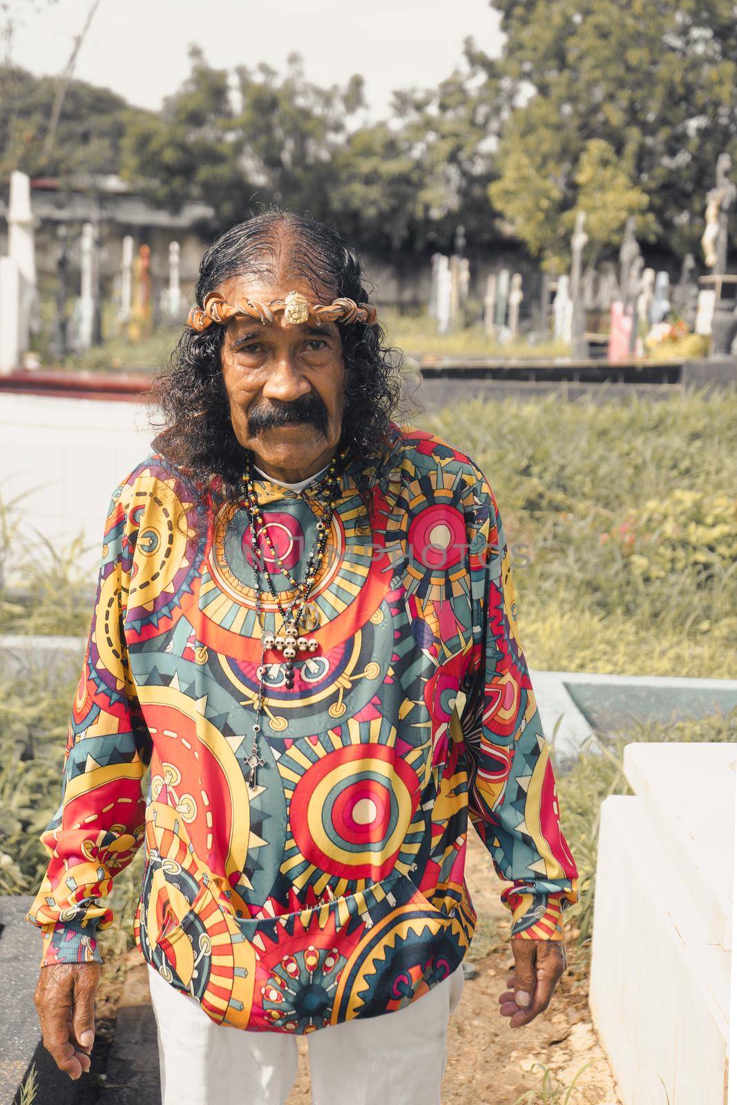 Impersonator of Jesus Christ with psychedelic clothes in a cemetery in Managua Nicaragua