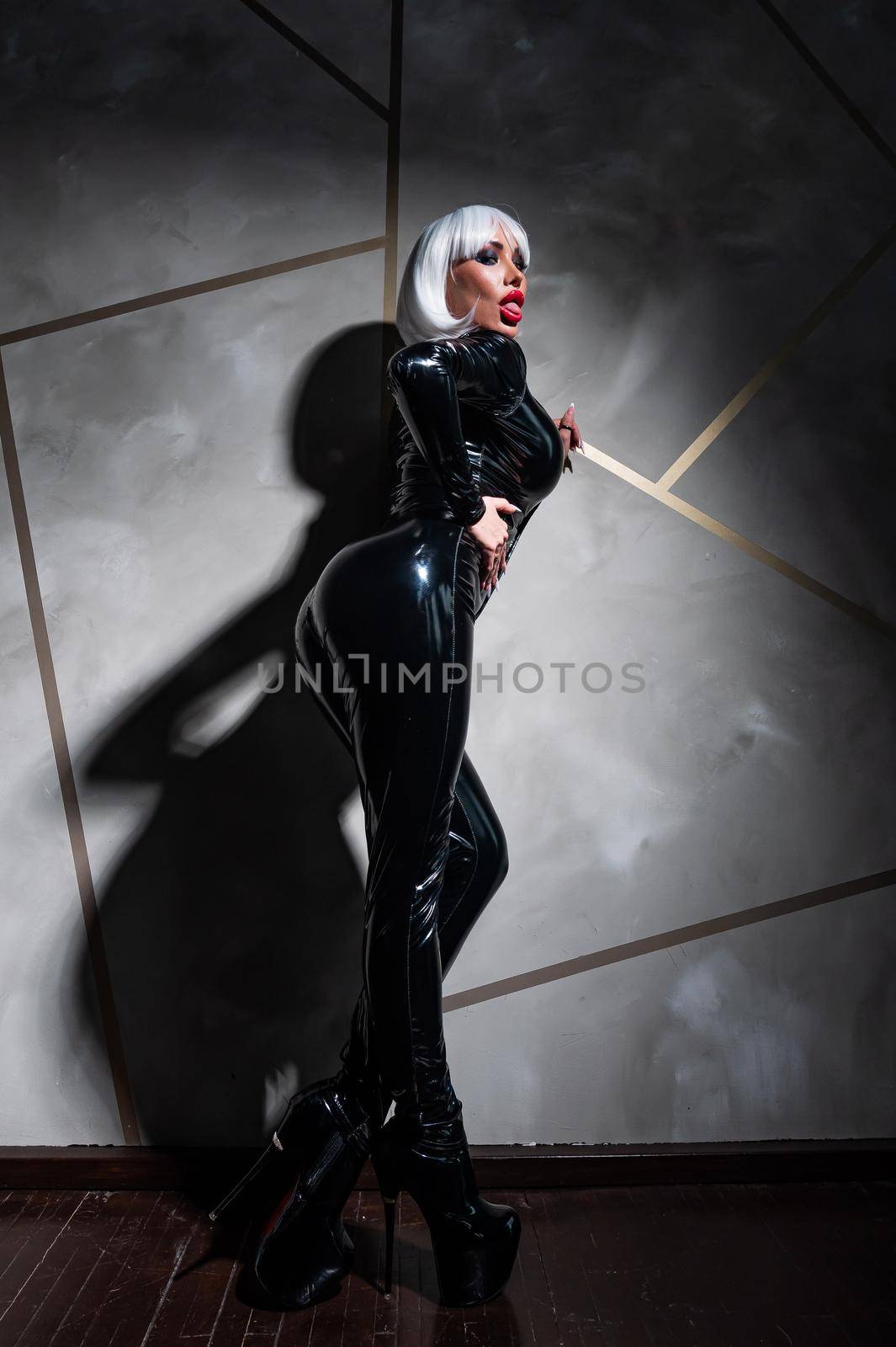 Sexy woman in a blonde wig and latex catsuit. Role-playing games by mrwed54