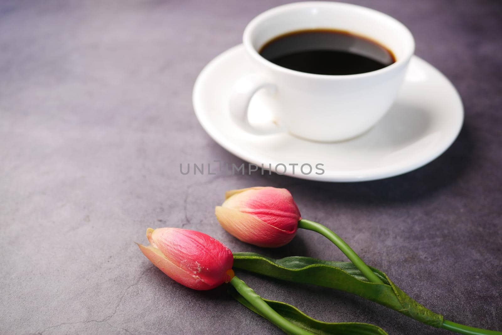 coffee, tulip flower on black background ..