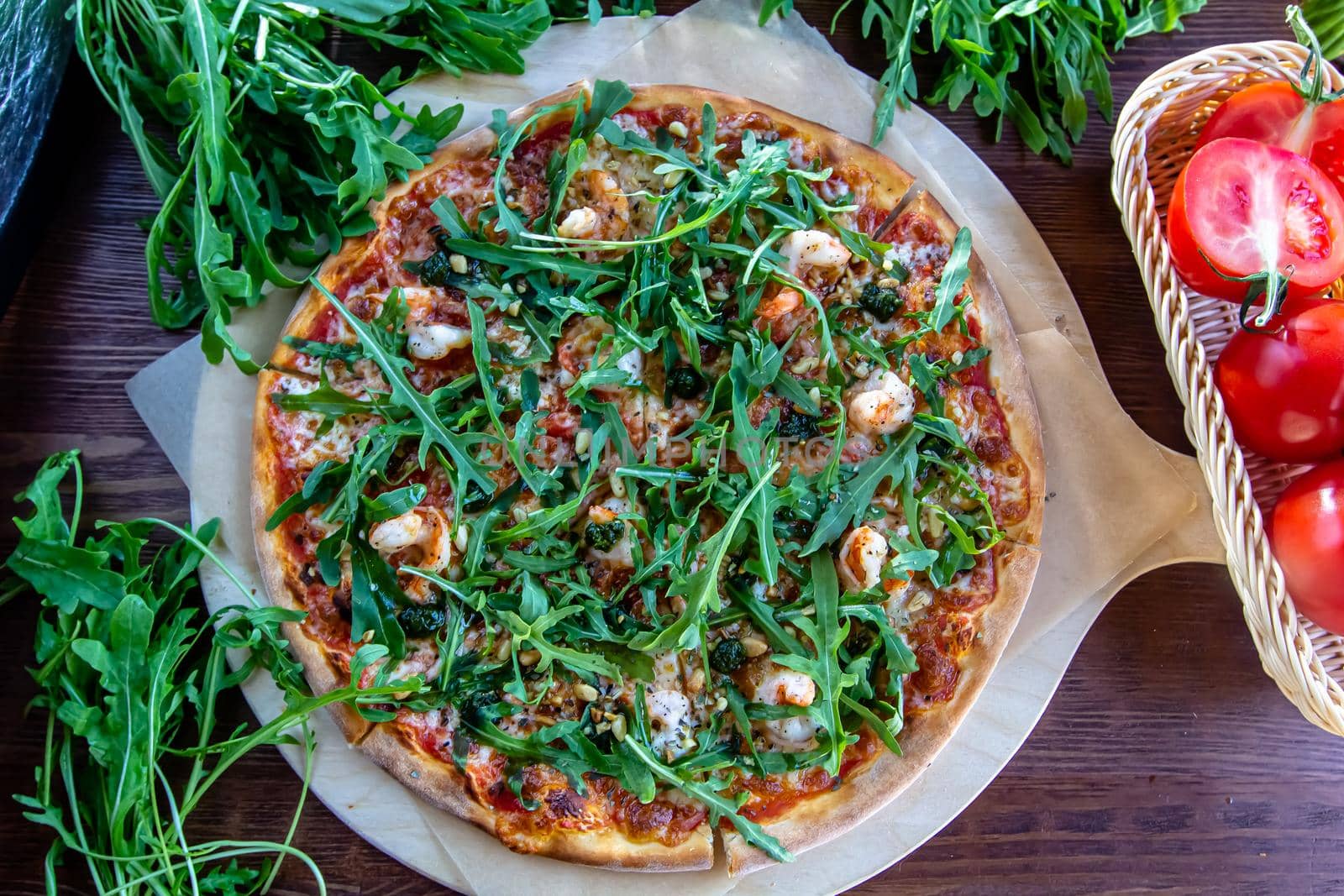 Delicious rustic Italian pizza with grilled Adriatic shrimps, mozzarella, sun dried tomatoes, arugula and parmesan cheese.