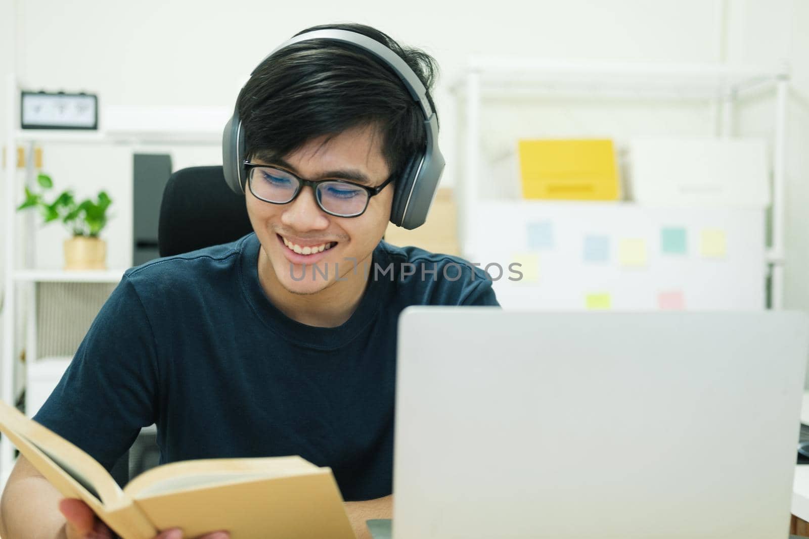 Young male student study at home. He using laptop and learning online.
