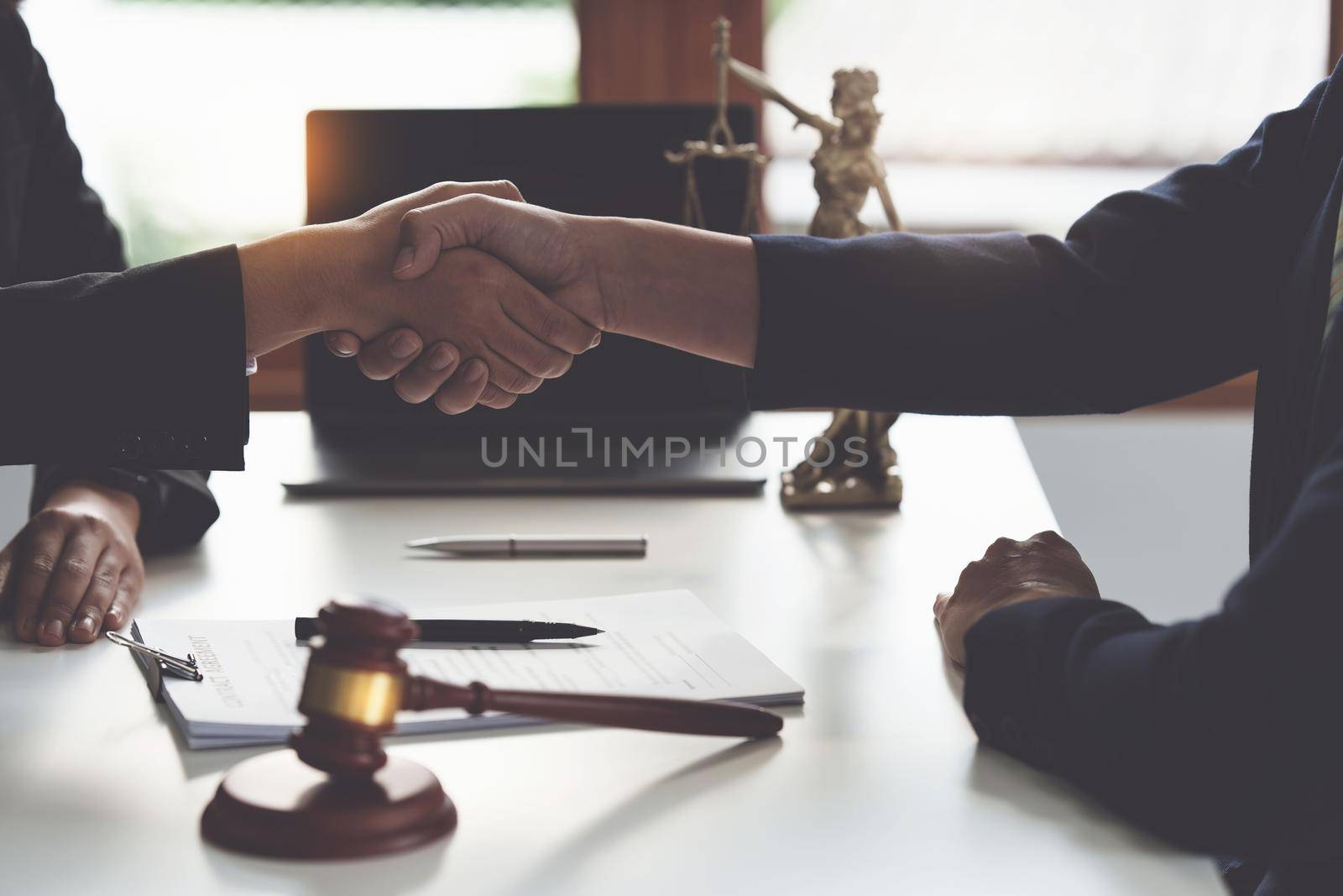 Business woman and lawyer shaking hand after discussing about agreement contract. Law, legal services, advice, Justice concept. by itchaznong