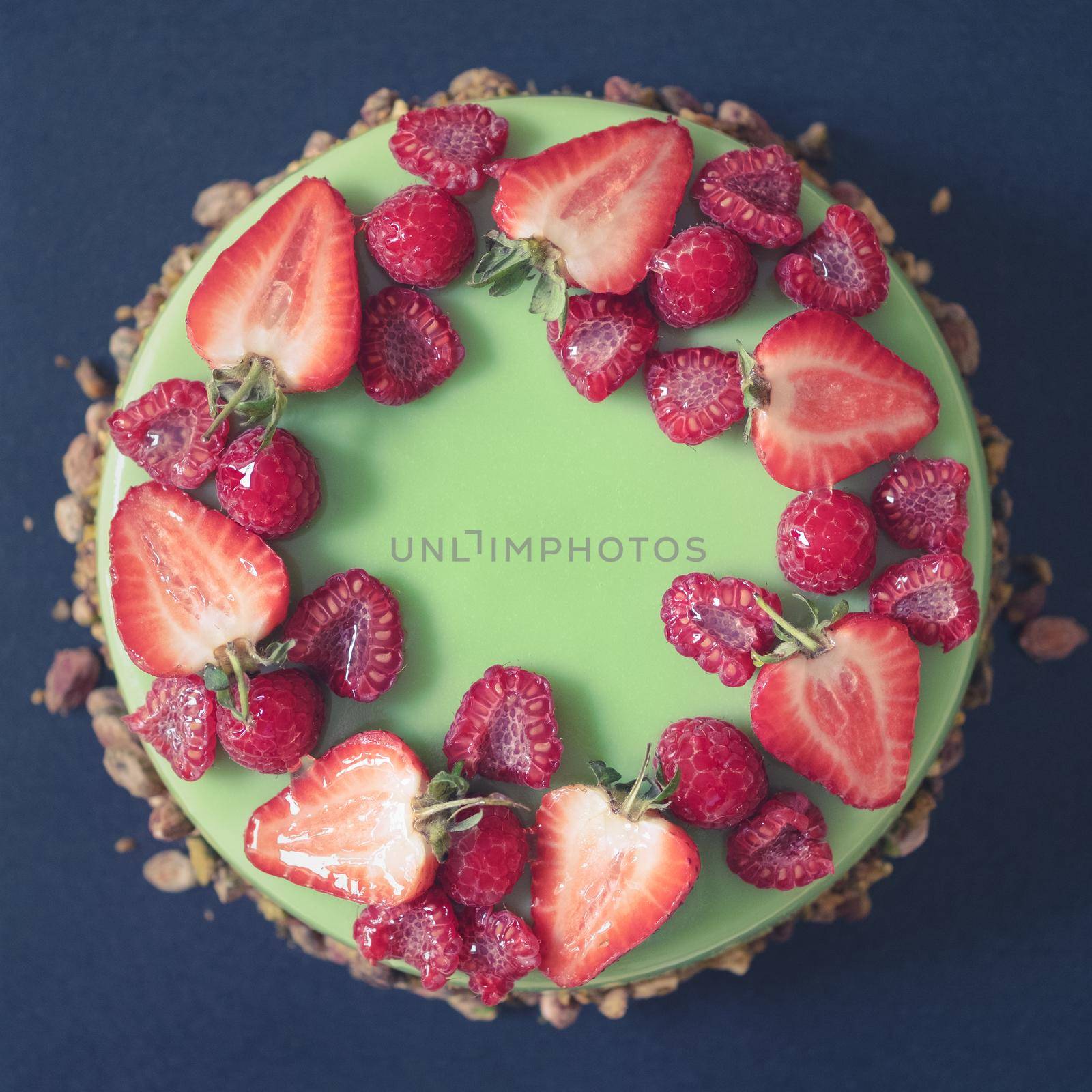 A Beautiful Pistachio Birthday Cake, Topped With Fresh Strawberries And Raspberries
