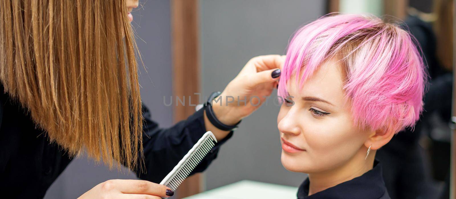 Young woman receiving short pink hairstyle by okskukuruza