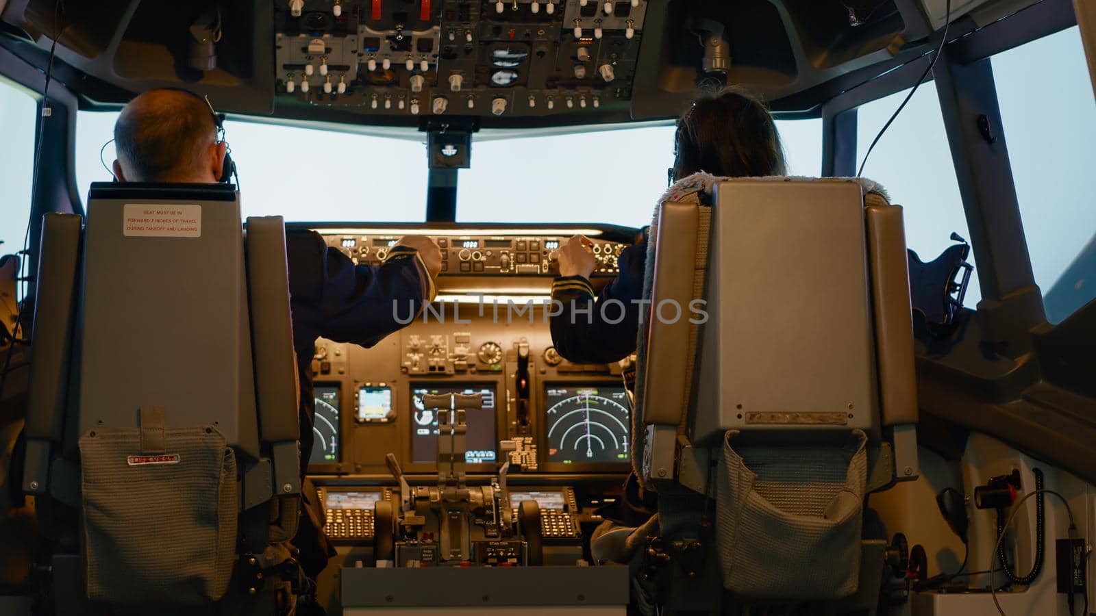 Plane captain and woman copilot fixing altitude on dashboard, using cockpit command with control panel to fly airplane. Aerial navigation to takeoff and use power engine, airline service.