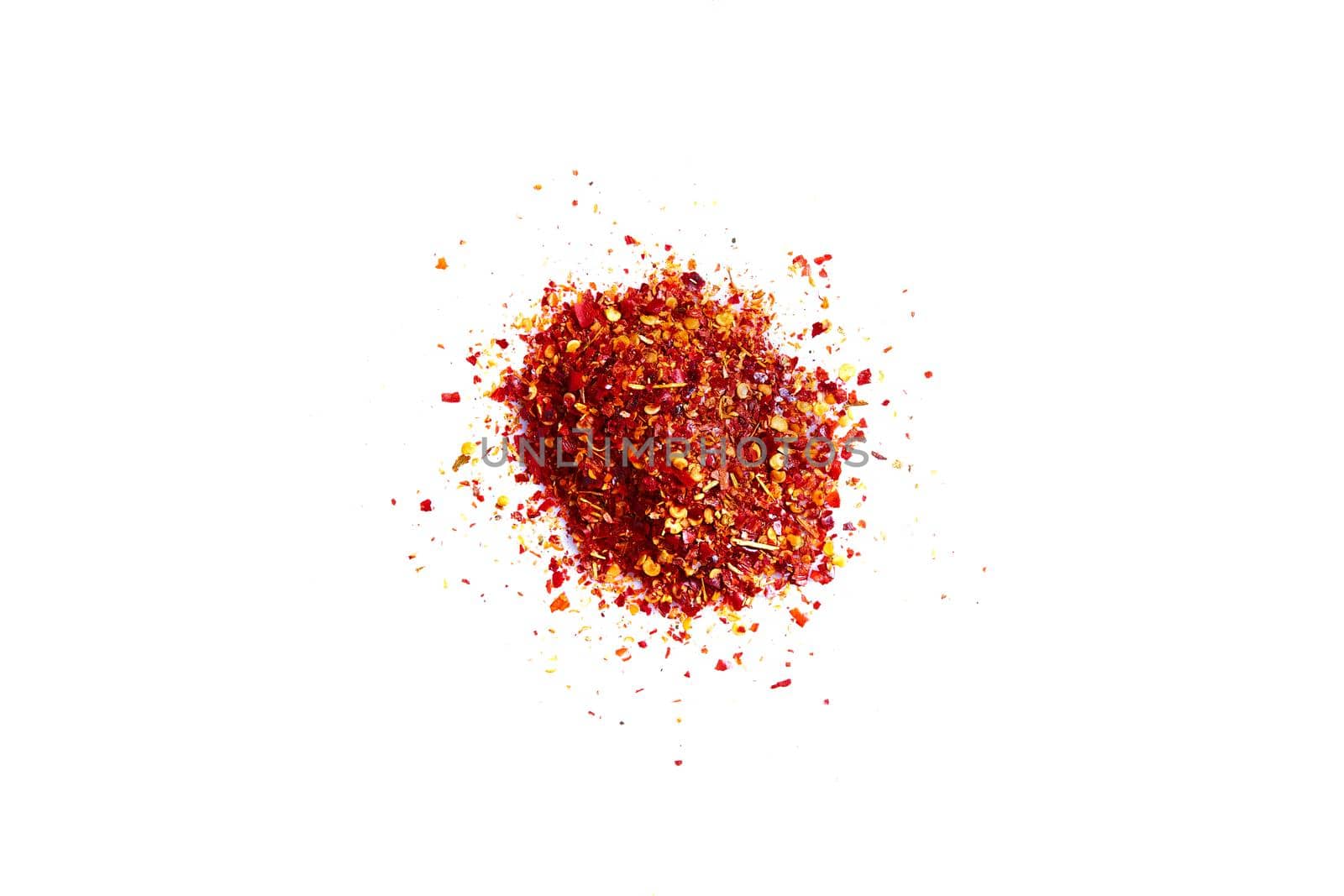 Crushed red pepper chilli pile from top on white background. Still life. Flat lay. Copy space. Spice