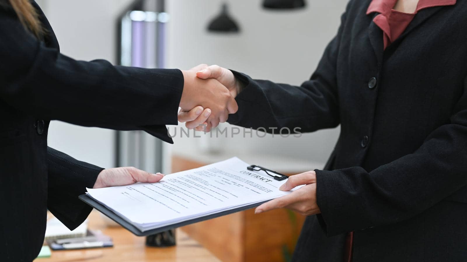 Cropped shot business partner shaking hands after finishing up a meeting or investment deal. Concept of teamwork and partnership by prathanchorruangsak