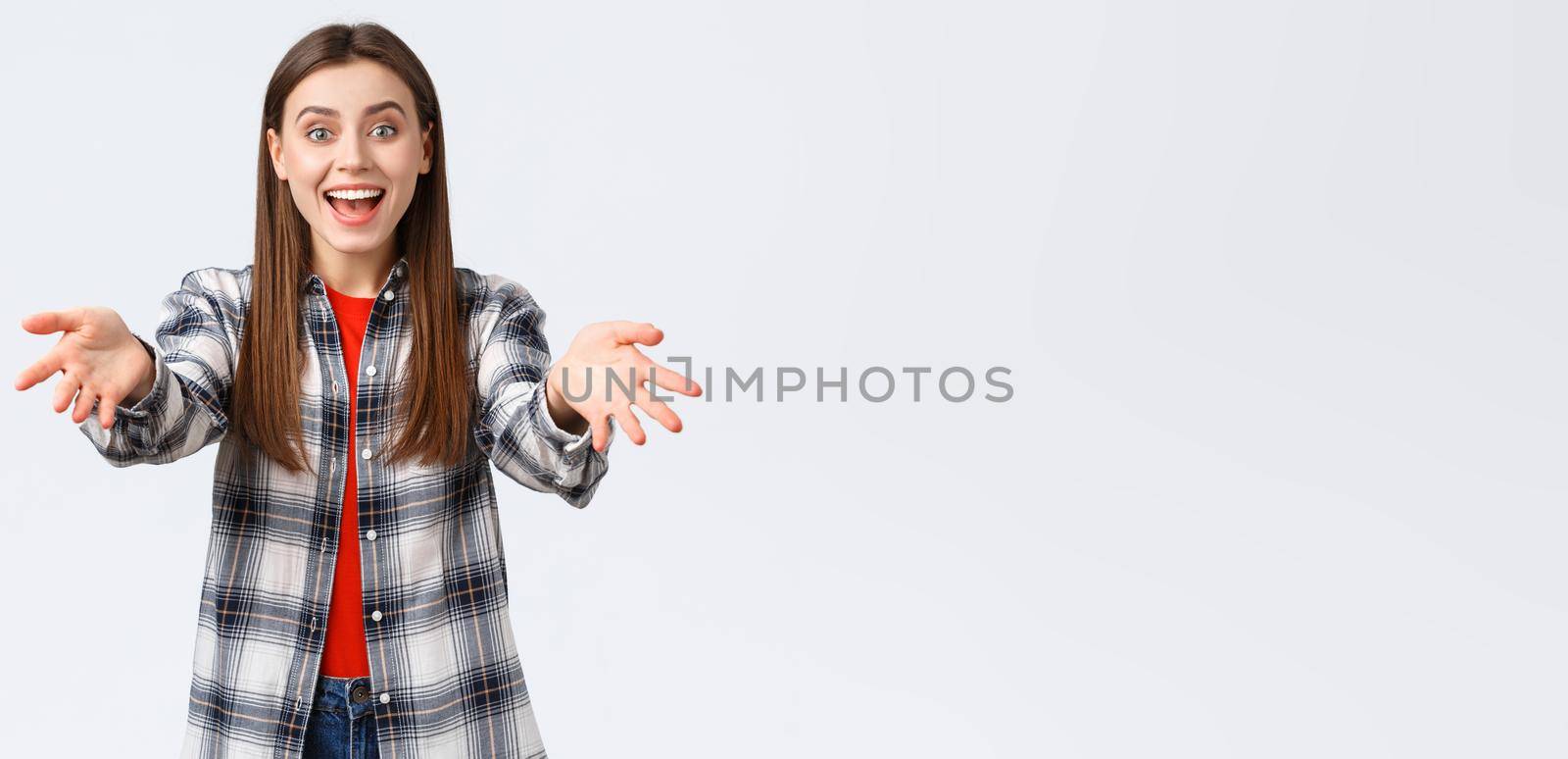 Lifestyle, different emotions, leisure activities concept. I am happy for you. Cheerful and excited young girl, attractive woman in checked shirt reach hands forward to hug and congratulate friend by Benzoix