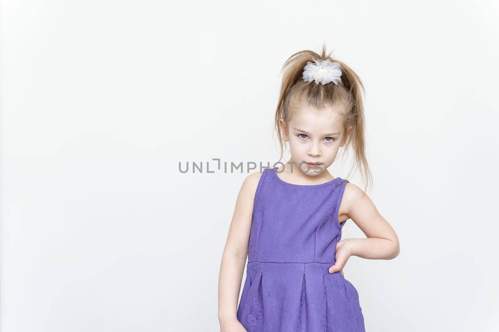 portrait of a cute 5 year old girl on a light background.