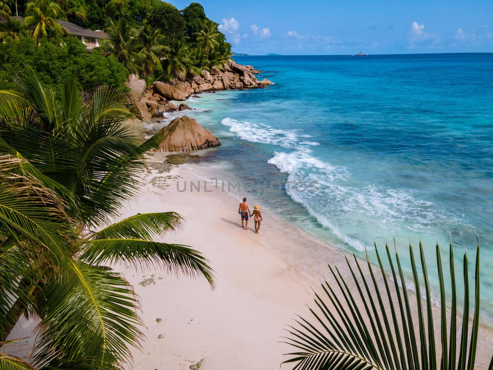 Anse Patates beach, La Digue Island, Seyshelles, Drone aerial view of La Digue Seychelles bird eye view.of tropical Island. mature couple men and women on vacation in Seychelles