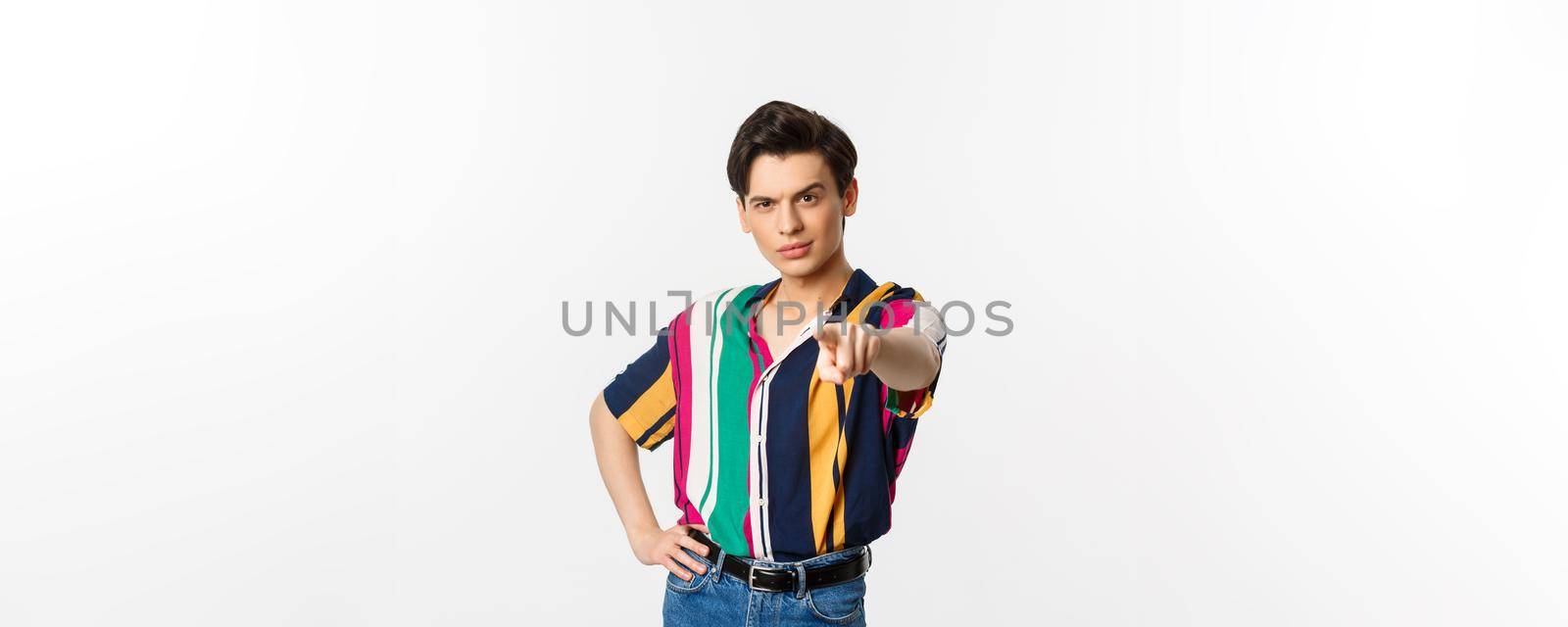 Sassy gay man pointing finger at camera, need you, picking or choosing, standing over white background by Benzoix