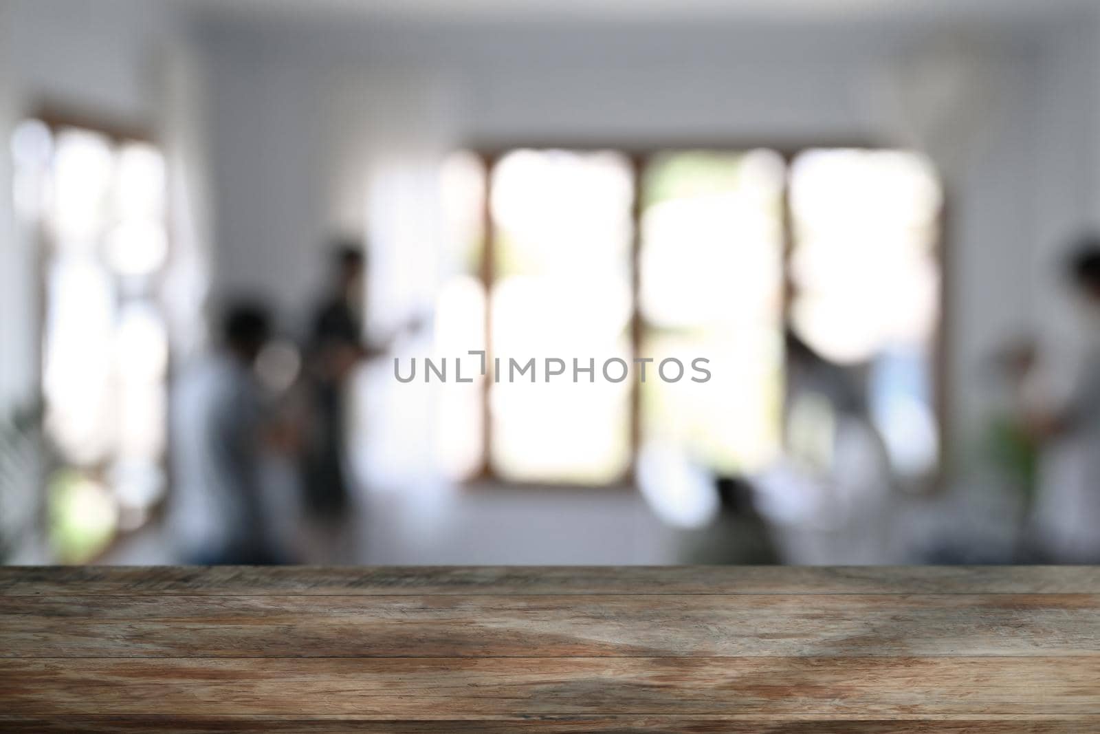 Wooden table in front of blurred background of restaurant. Copy space for advertising text or montage your products. by prathanchorruangsak