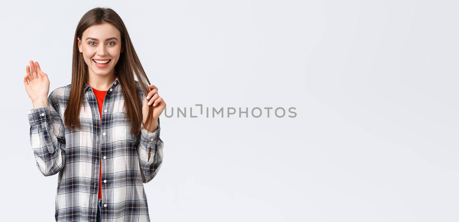 Lifestyle, different emotions, leisure activities concept. Friendly attractive young woman saying hi or bye, waving hand in greeting with happy enthusiastic smile, meeting fellow students by Benzoix