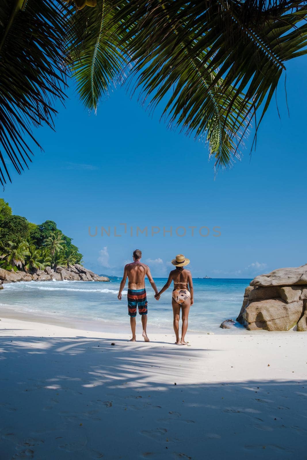 Anse Patates beach, La Digue Island, Seyshelles, Drone aerial view of La Digue Seychelles bird eye view.of tropical Island. mature couple men and women on vacation in Seychelles