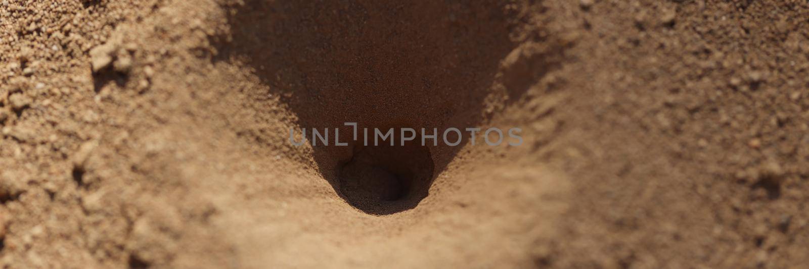 Old small hole in ground or steppe or field with texture of soil and sand by kuprevich