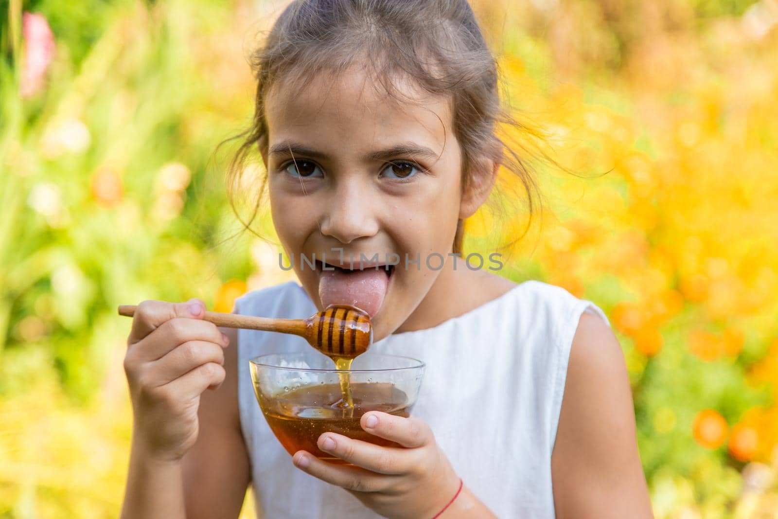 The child eats flower honey. Selective focus. Nature.