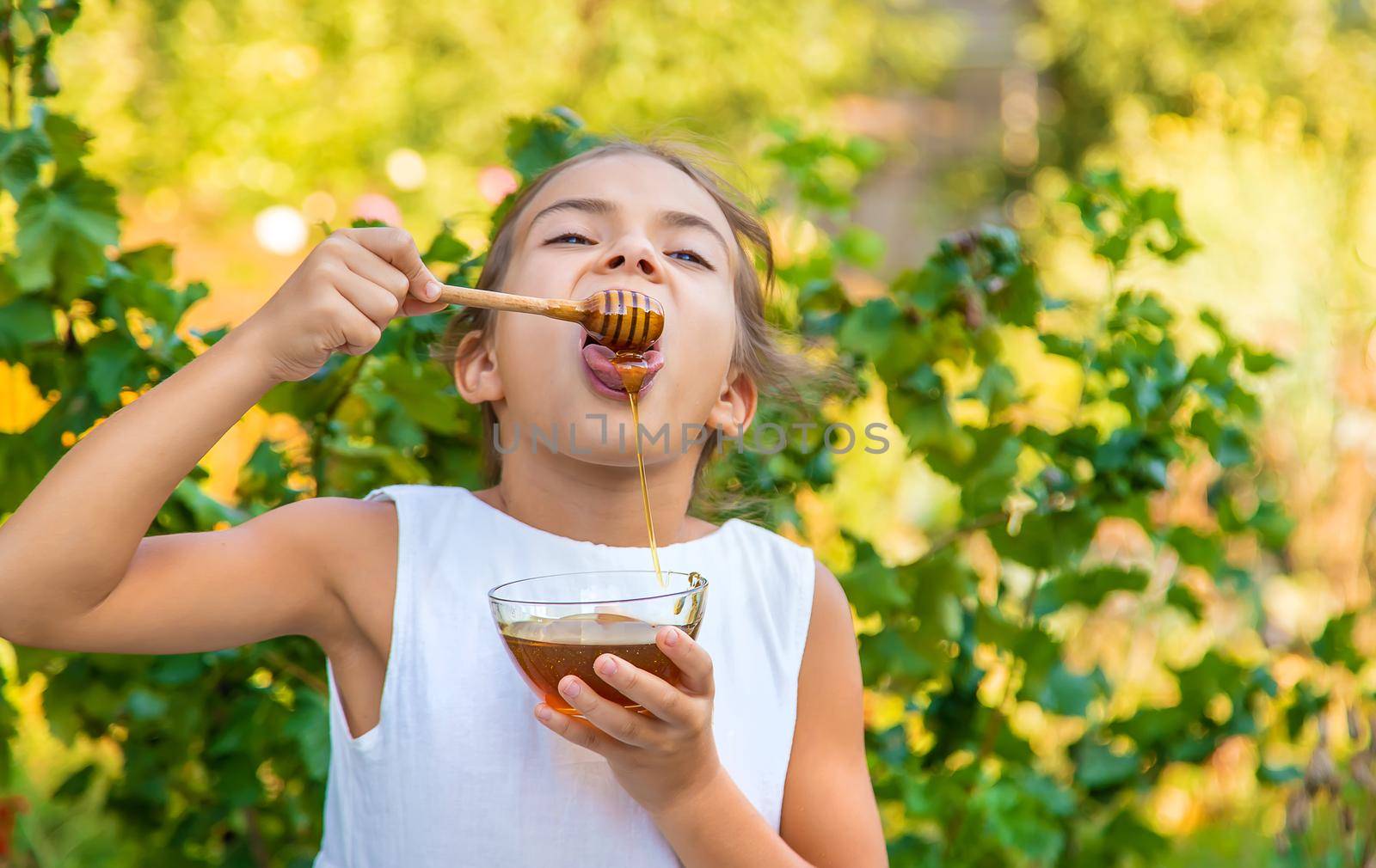 The child eats flower honey. Selective focus. by yanadjana