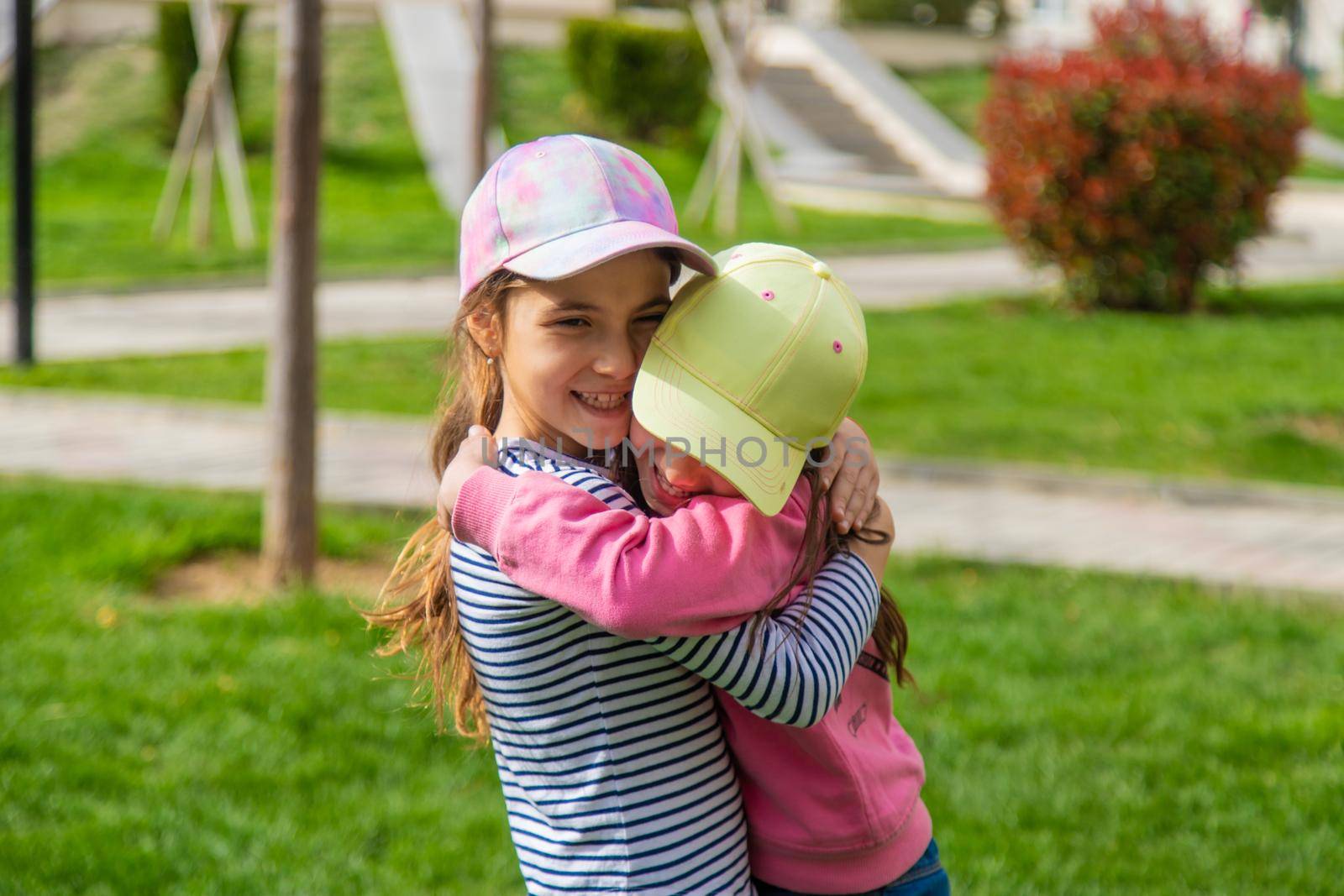 girlfriends children hugging in the park.selective focus by mila1784